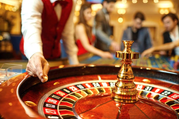Boom City slot game interface showing reels, stake controls, and balance display